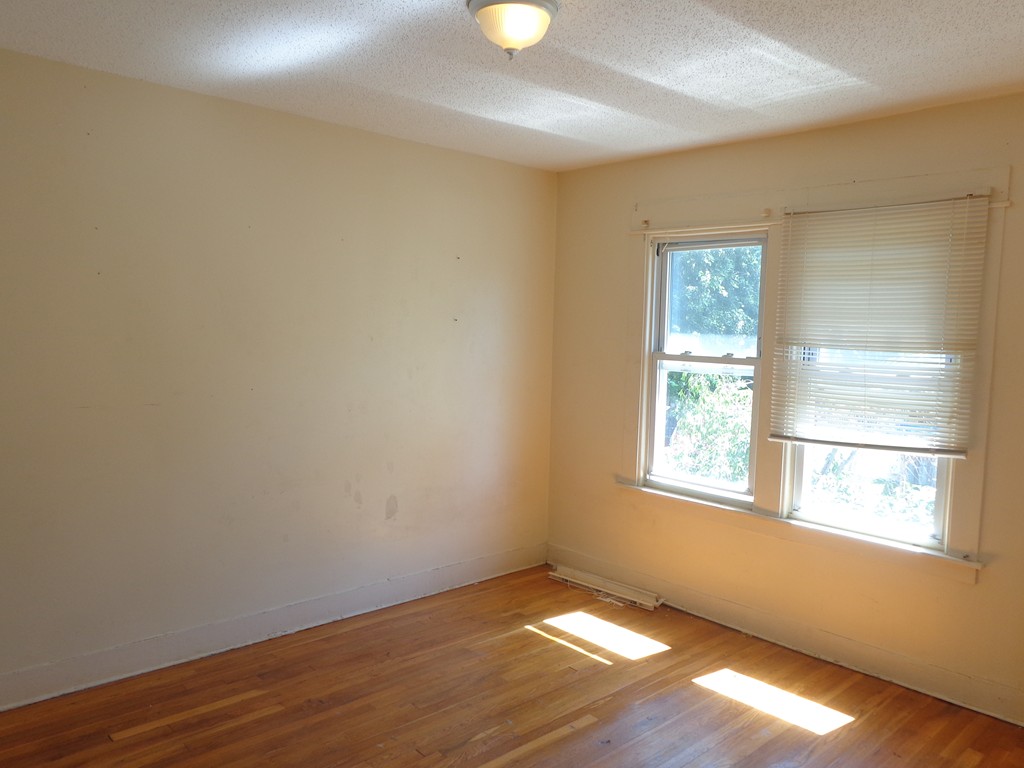39-41 Ralph Street Springfield, MA 01109 - Photo 11 of 13 an empty room with wooden floor and windows