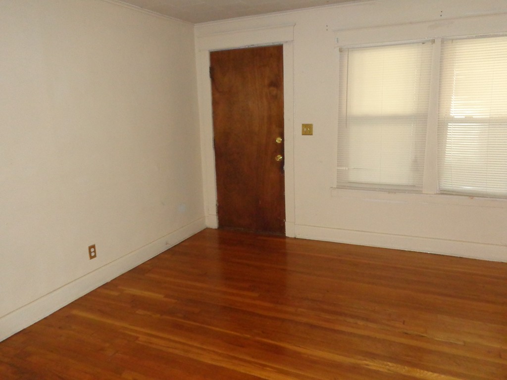 39-41 Ralph Street Springfield, MA 01109 - Photo 4 of 13 an empty room with wooden floor and windows