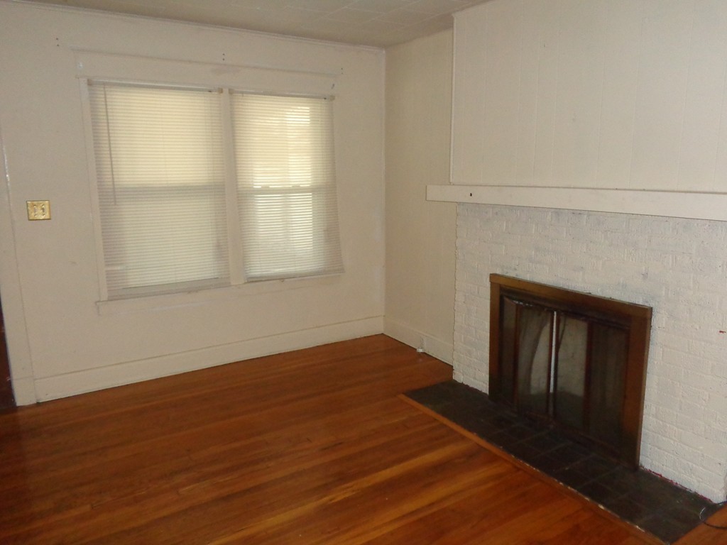 39-41 Ralph Street Springfield, MA 01109 - Photo 5 of 13 a view of an empty room with wooden floor and a window
