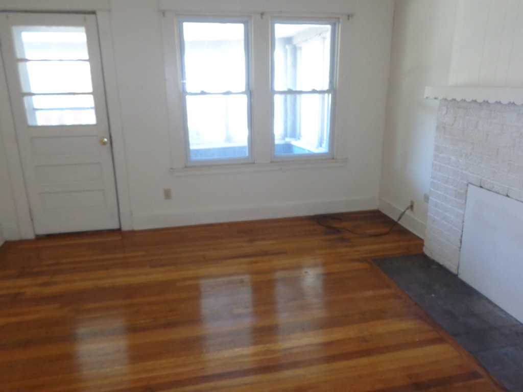 39-41 Ralph Street Springfield, MA 01109 - Photo 9 of 13 an empty room with wooden floor and windows
