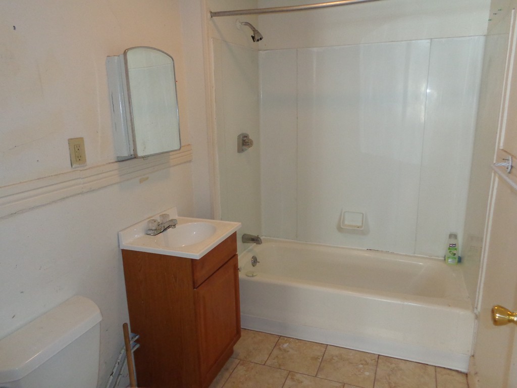 39-41 Ralph Street Springfield, MA 01109 - Photo 10 of 13 a bathroom with a sink a toilet and shower