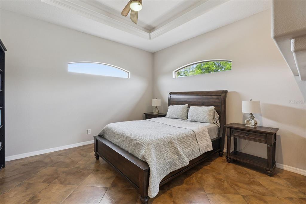 7139 Groveland Farms Road Groveland, FL 34736 - Photo 11 of 36 a bedroom with a bed and a chandelier