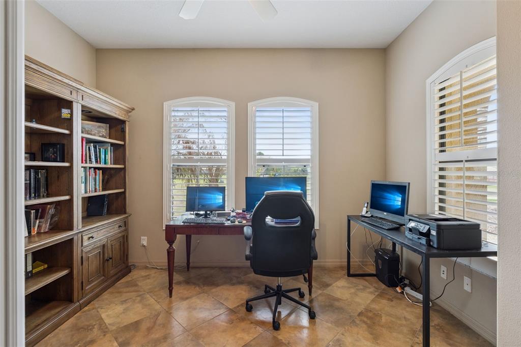 7139 Groveland Farms Road Groveland, FL 34736 - Photo 17 of 36 a view of a workspace with furniture and a window