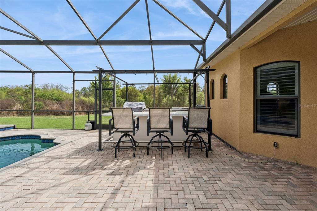 7139 Groveland Farms Road Groveland, FL 34736 - Photo 25 of 36 a view of a patio with a table and chairs under an umbrella