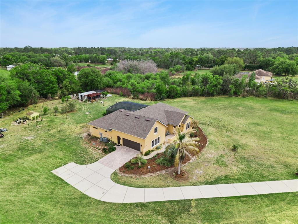 7139 Groveland Farms Road Groveland, FL 34736 - Photo 28 of 36 a view of a house with a yard