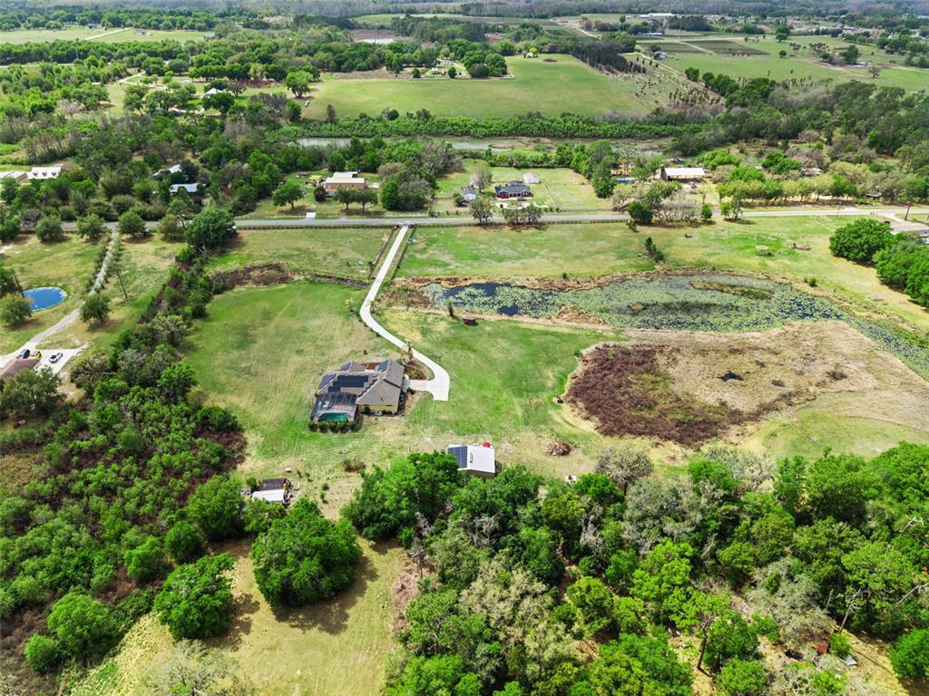7139 Groveland Farms Road Groveland, FL 34736 - Photo 29 of 36 an aerial view of a houses with a yard