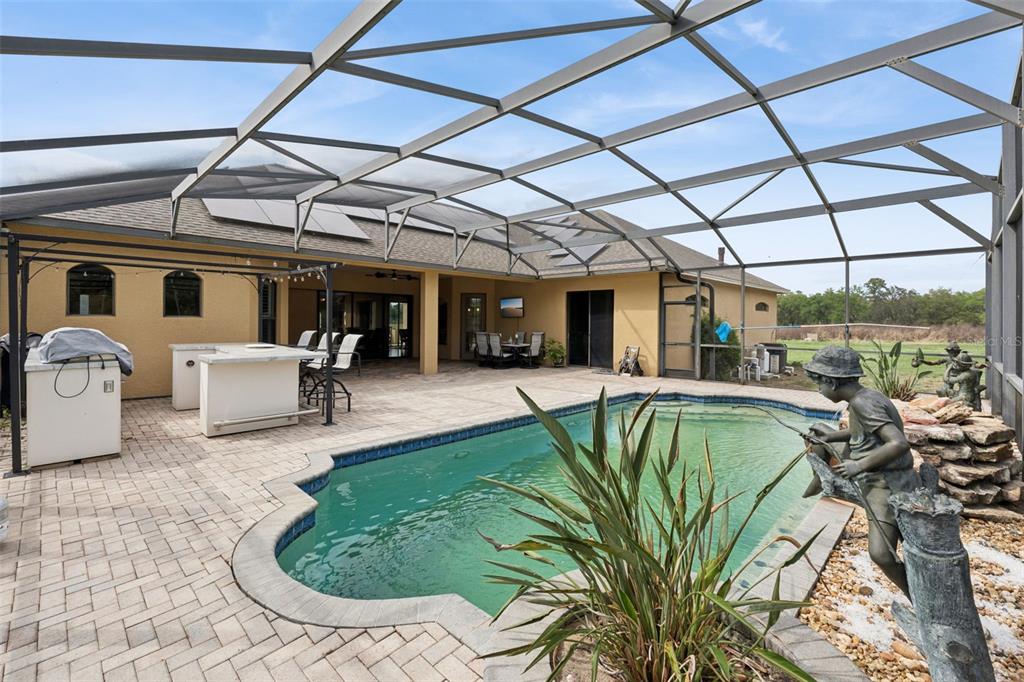 7139 Groveland Farms Road Groveland, FL 34736 - Photo 3 of 36 a view of a patio with table and chairs with wooden floor