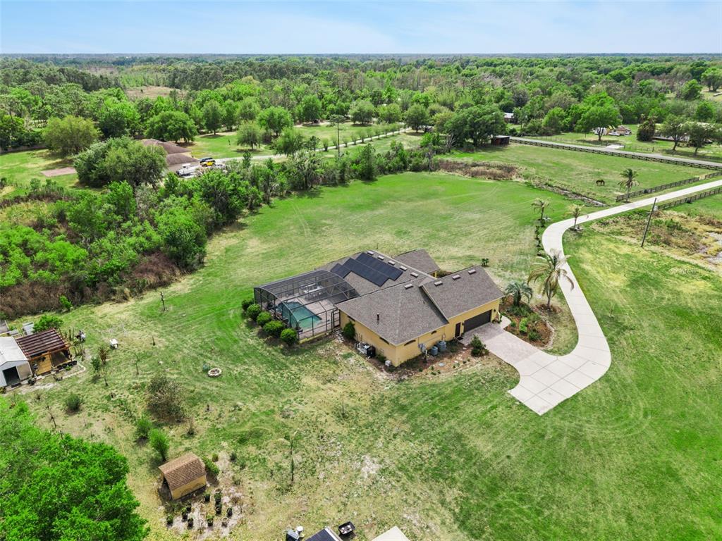 7139 Groveland Farms Road Groveland, FL 34736 - Photo 31 of 36 an aerial view of a house with yard and green space