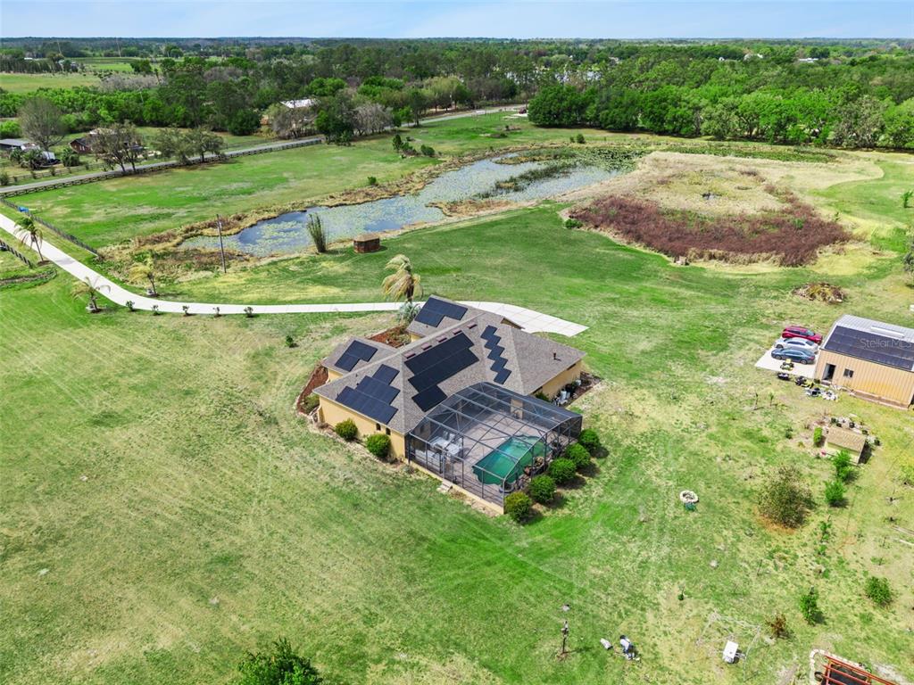 7139 Groveland Farms Road Groveland, FL 34736 - Photo 32 of 36 an aerial view of a house with a yard and lake view