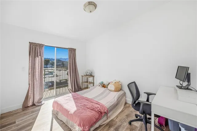 a bedroom with a bed and a desk