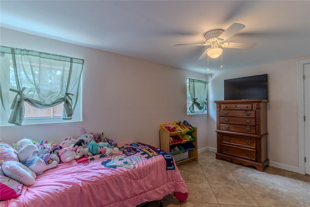 147 Hayes Street Lake Wales, FL 33859 - Photo 11 of 31 a bedroom with a bed and a chandelier