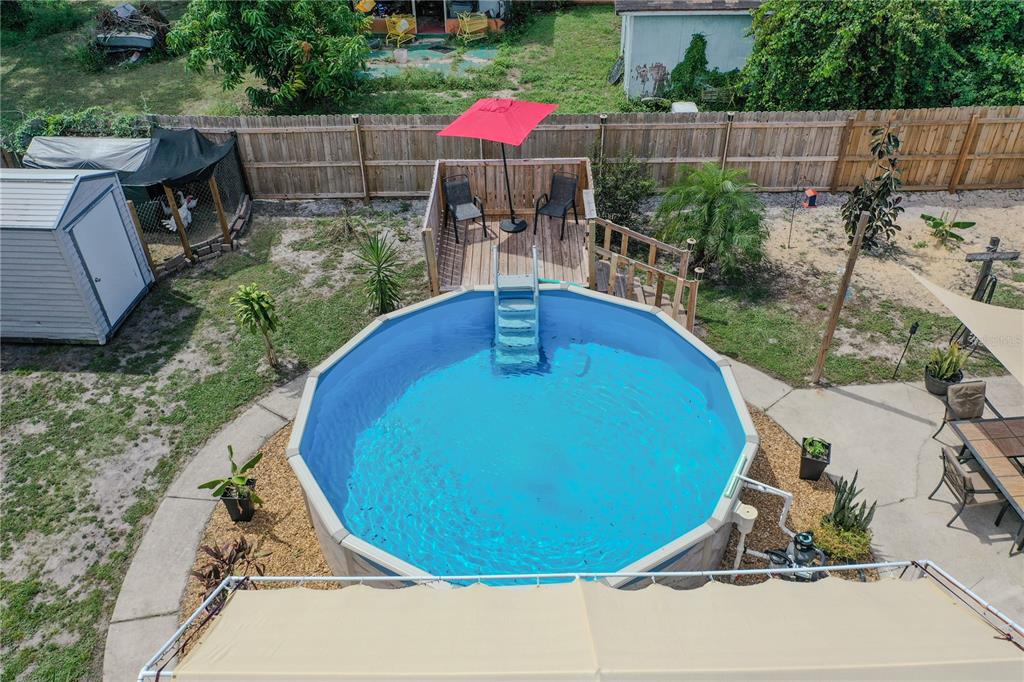147 Hayes Street Lake Wales, FL 33859 - Photo 19 of 31 a view of a backyard with table and chairs potted plants and wooden fence