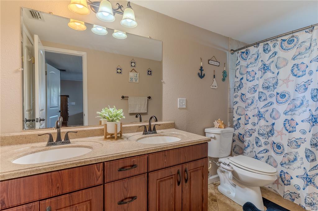 147 Hayes Street Lake Wales, FL 33859 - Photo 9 of 31 a bathroom with a double vanity sink mirror and toilet