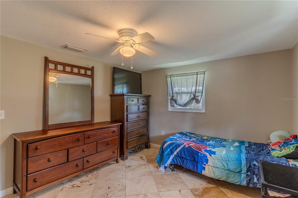 147 Hayes Street Lake Wales, FL 33859 - Photo 10 of 31 a bedroom with a bed and a dresser in it