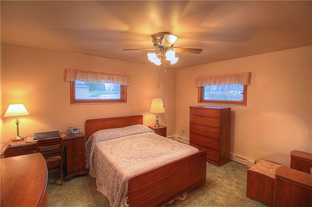 133 Wall Street Rochester, PA 15074 - Photo 14 of 25 Master Bedroom at front of the home offers hardwood flooring under the area rug, privacy windows and ceiling fan.