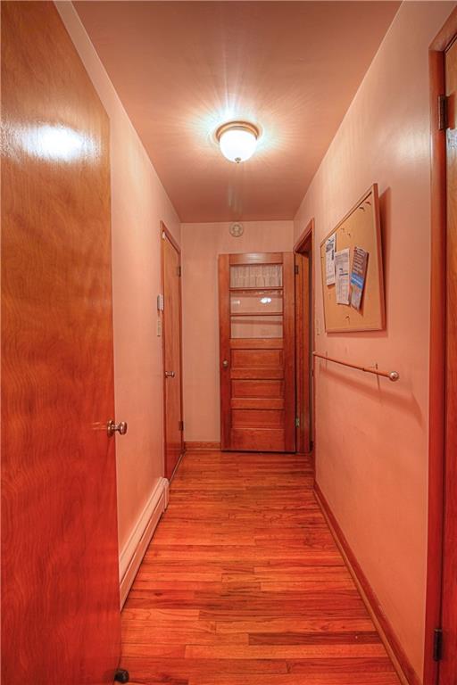 133 Wall Street Rochester, PA 15074 - Photo 5 of 25 This hallway is also graced with hardwood flooring. It offers a pantry (right), the attached garage access at left and access to the lower level at far right.