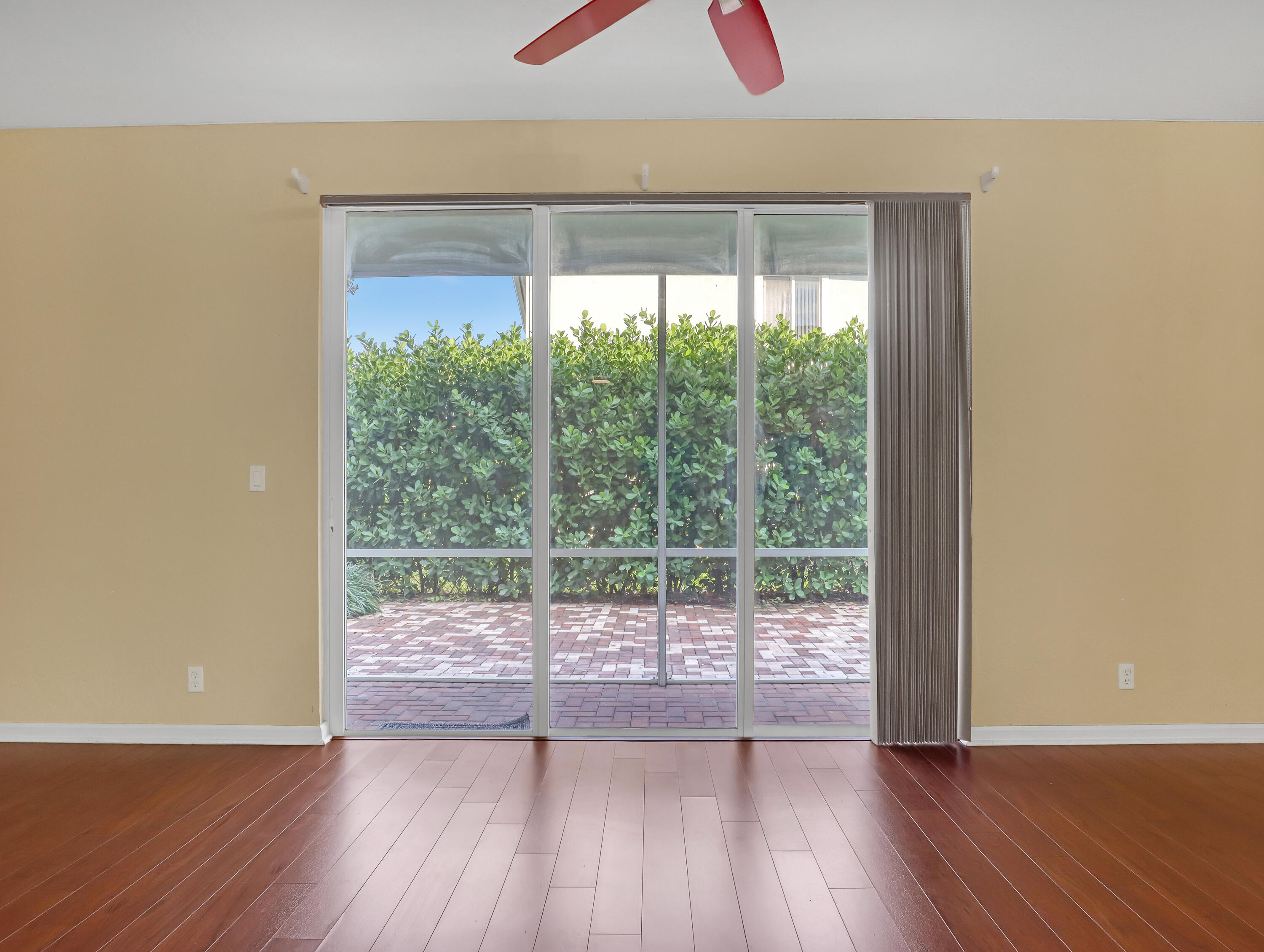 2226 Oakmont Drive Riviera Beach, FL 33404 - Photo 9 of 38 wooden floor in an empty room with a window