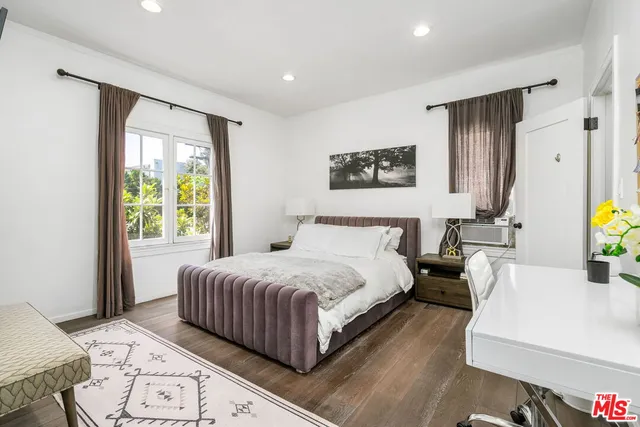 a bedroom with a large bed and a window