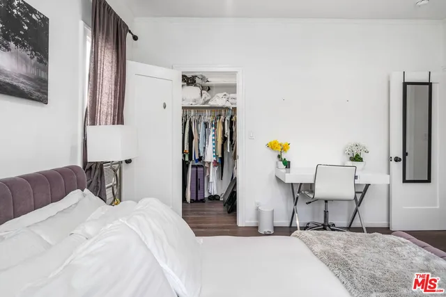 a bedroom with a bed and a chair