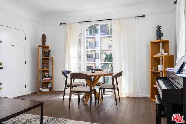 a dining room with furniture and wooden floor