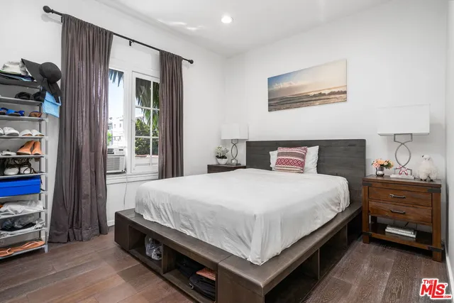 a bedroom with a bed and a night stand