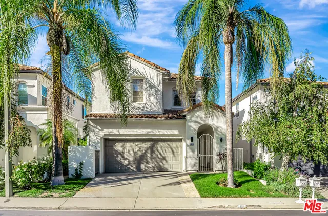 a front view of a multi story building with a yard