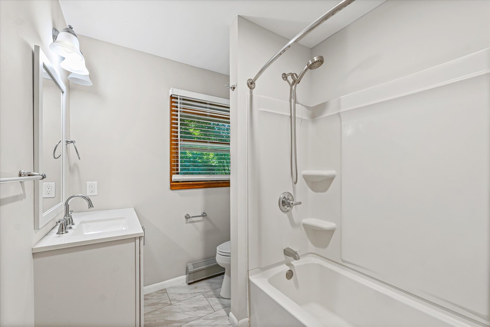 1507 West Columbia Avenue Champaign, IL 61821 - Photo 22 of 28 a bathroom with a granite countertop sink a toilet and shower