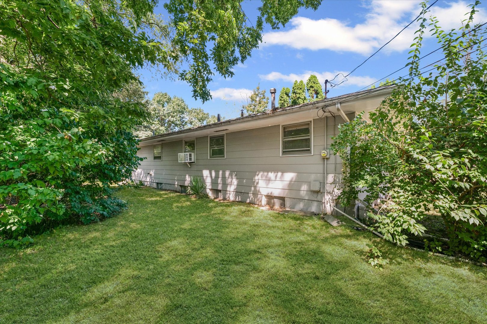 1507 West Columbia Avenue Champaign, IL 61821 - Photo 25 of 28 a view of a house with a yard and a garden