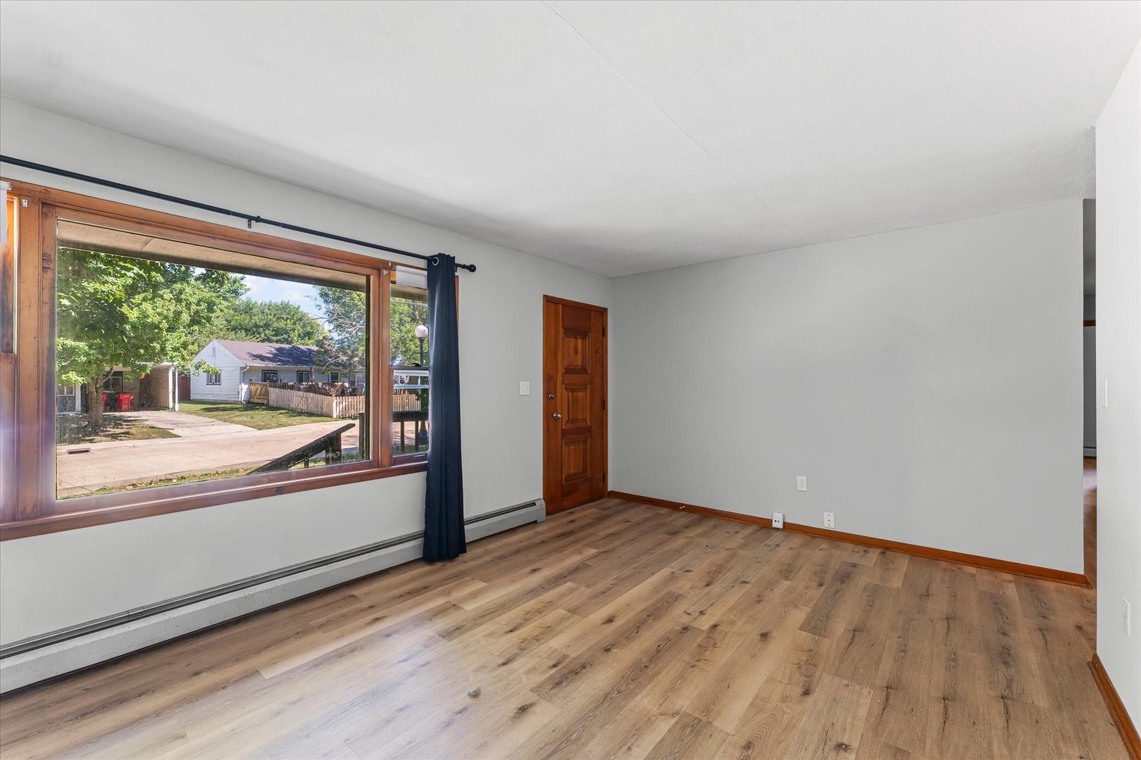 1507 West Columbia Avenue Champaign, IL 61821 - Photo 7 of 28 a view of an empty room with wooden floor and a window