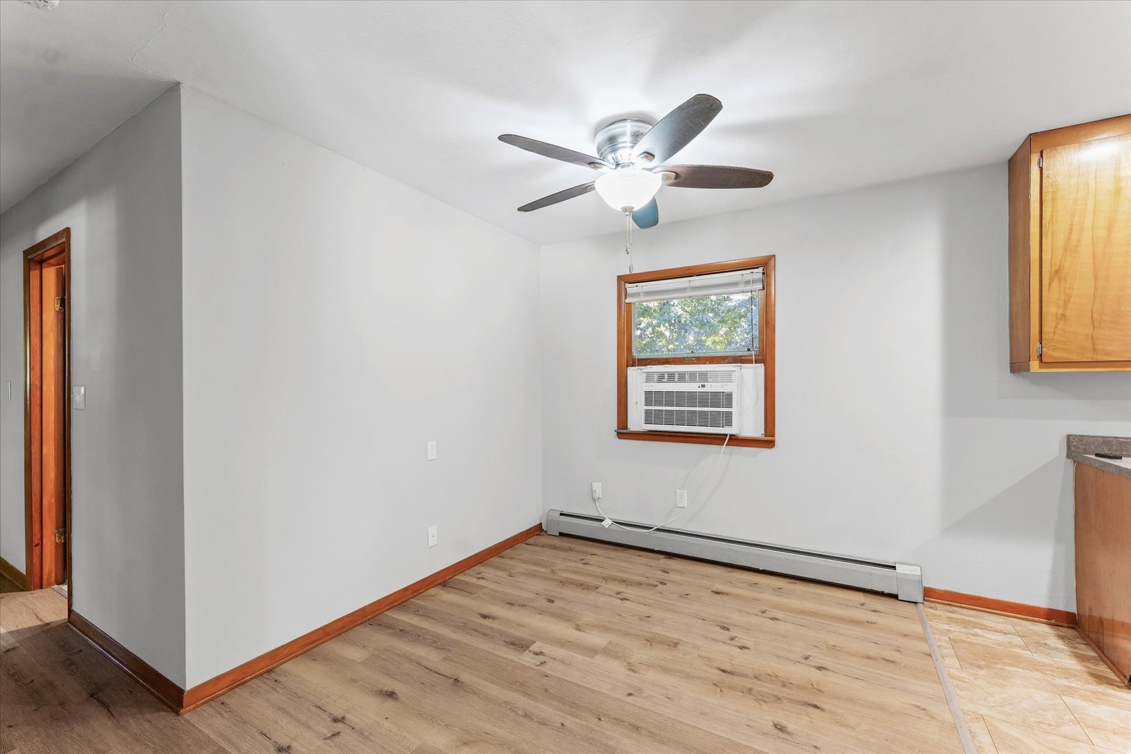 1507 West Columbia Avenue Champaign, IL 61821 - Photo 9 of 28 a view of an empty room with wooden floor and a window