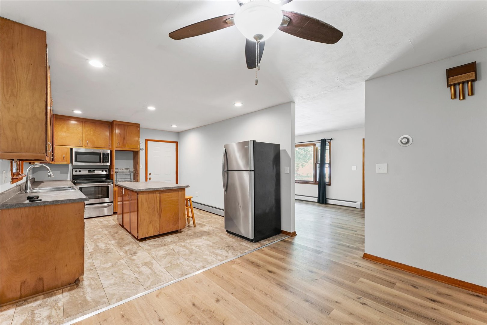 1507 West Columbia Avenue Champaign, IL 61821 - Photo 10 of 28 a view of kitchen with stainless steel appliances refrigerator stove and wooden floor