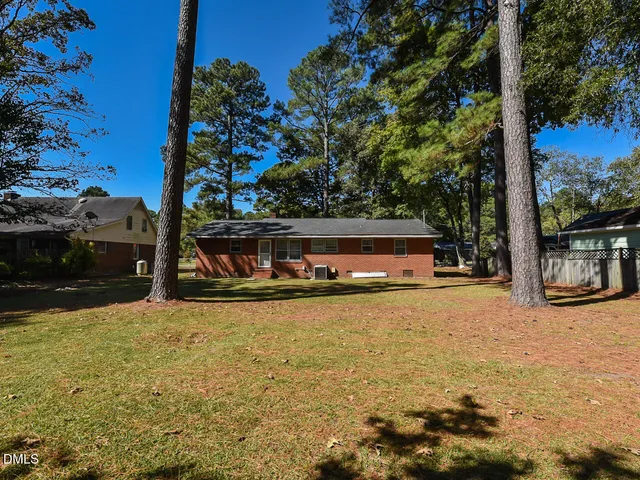 a view of back yard of the house with a swimming pool