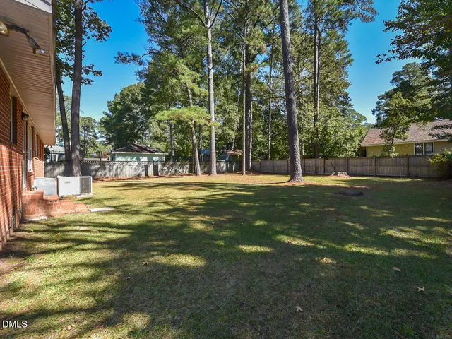 a view of a park with large trees