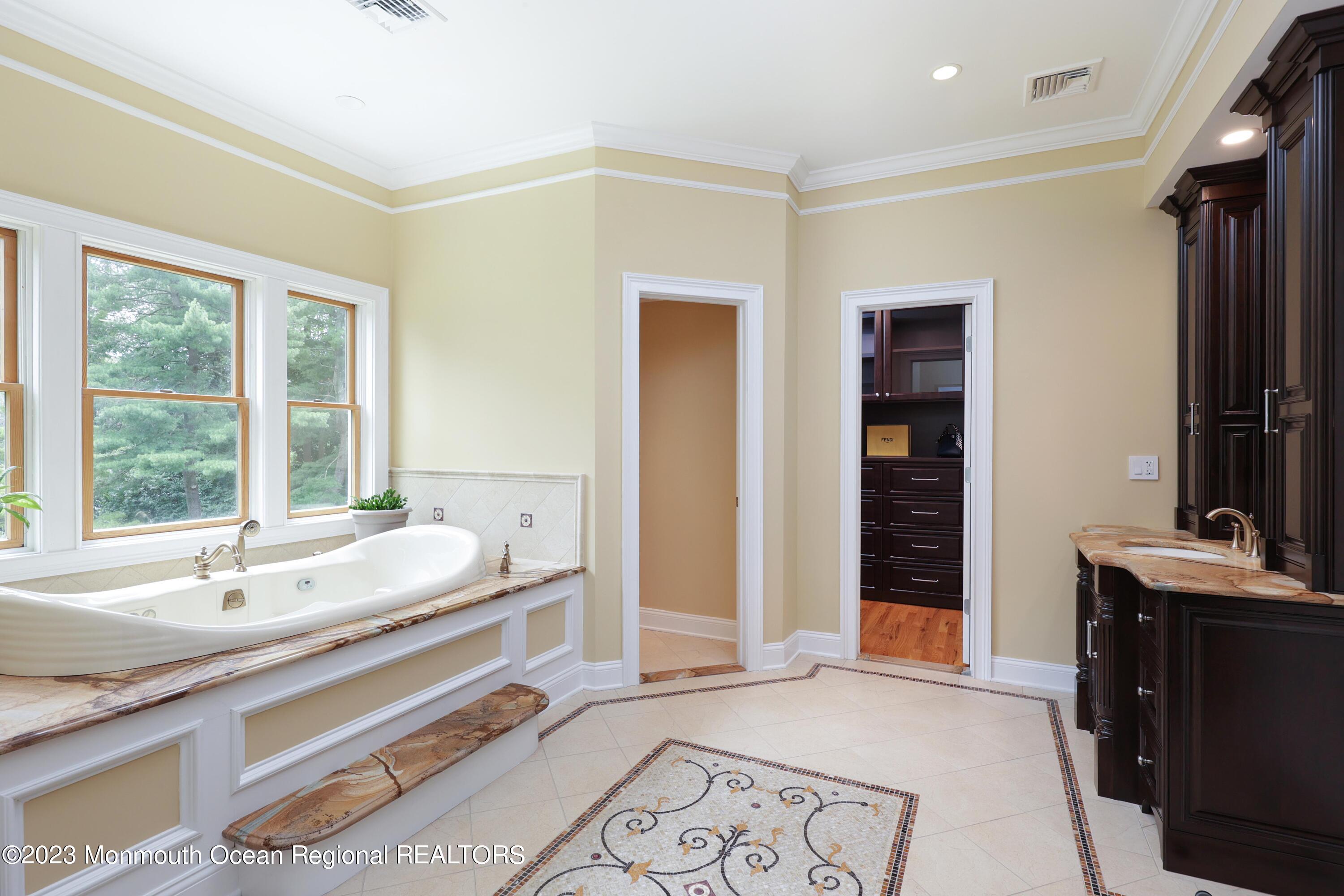 113 Ballantine Road Middletown, NJ 07748 - Photo 11 of 15 a spacious bathroom with a tub and a sink