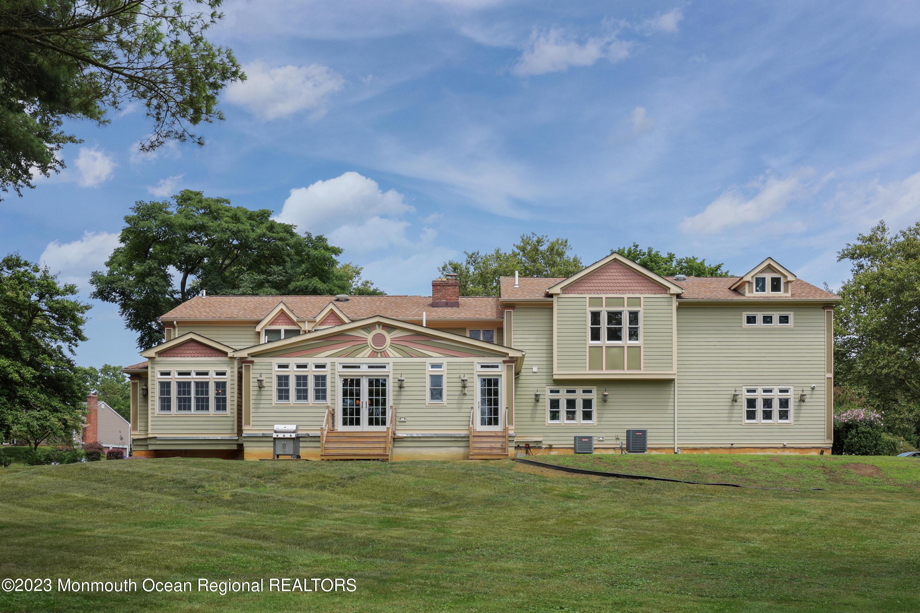 113 Ballantine Road Middletown, NJ 07748 - Photo 15 of 15 a front view of a house with a garden