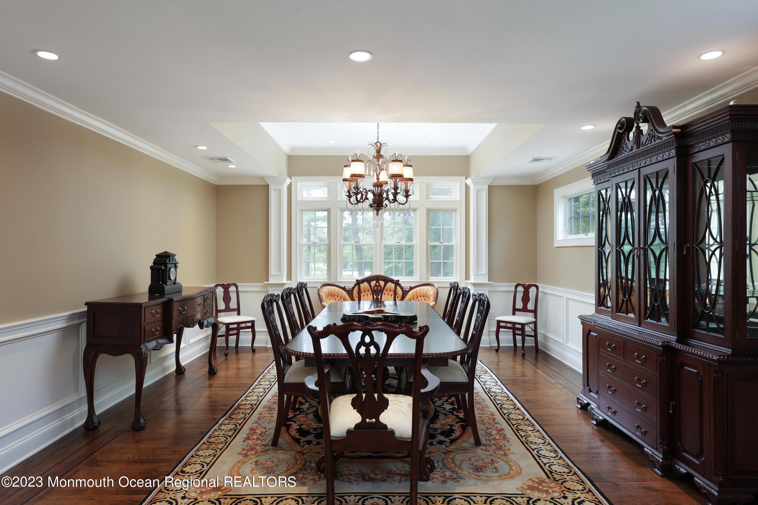 113 Ballantine Road Middletown, NJ 07748 - Photo 5 of 15 a dining room with furniture a rug and a chandelier