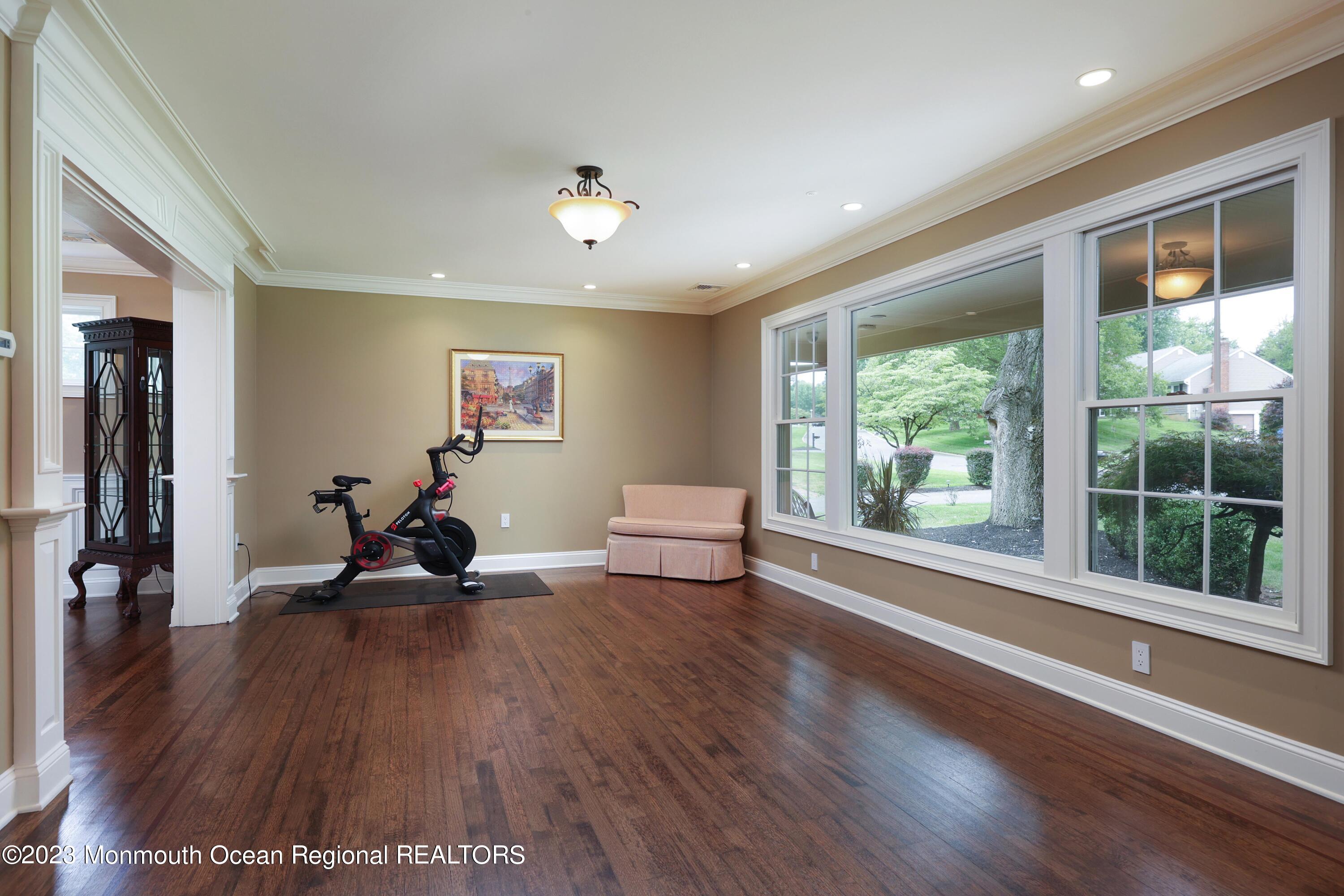 113 Ballantine Road Middletown, NJ 07748 - Photo 7 of 15 a view of a room with gym equipment and a large window