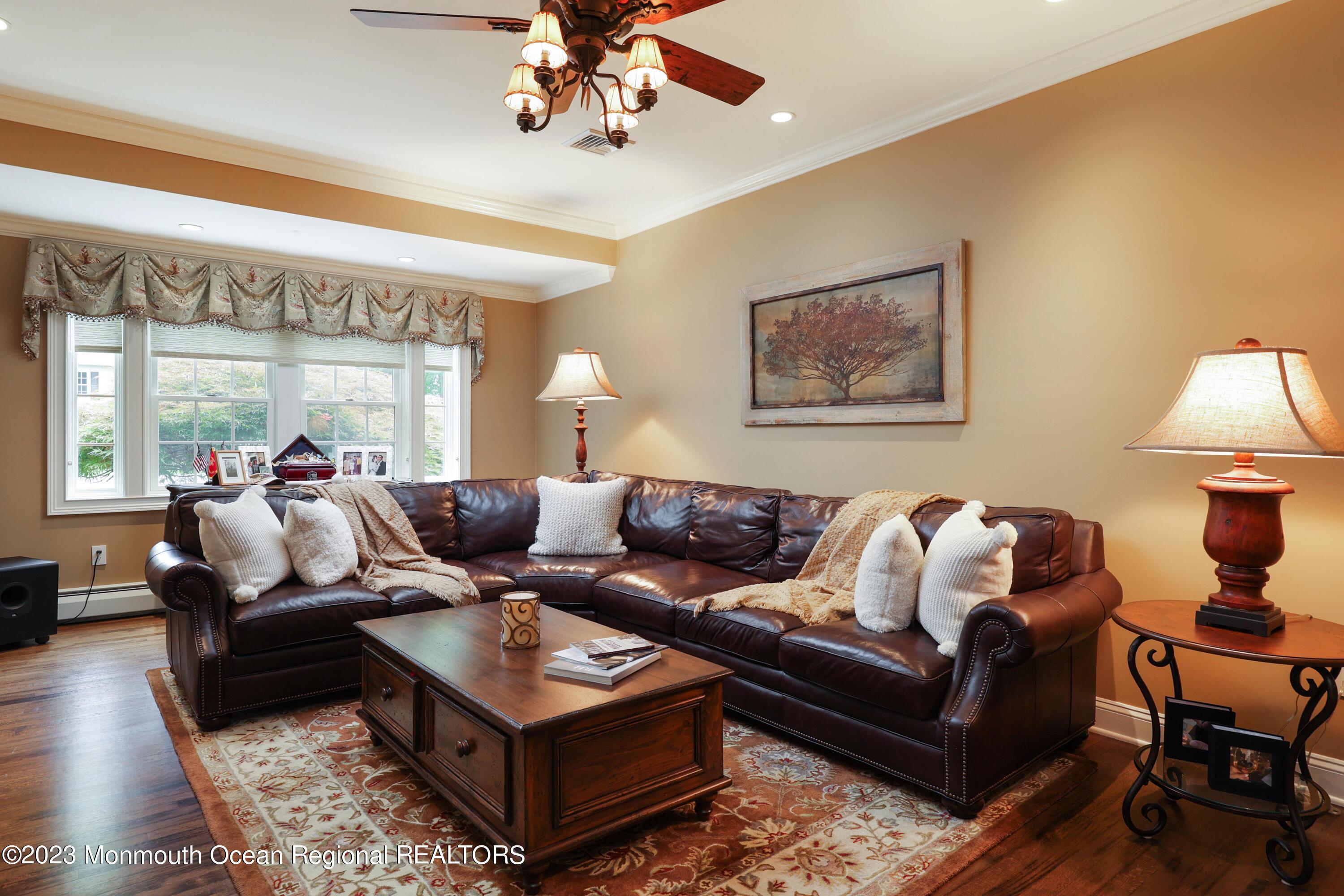 113 Ballantine Road Middletown, NJ 07748 - Photo 8 of 15 a living room with furniture and a chandelier