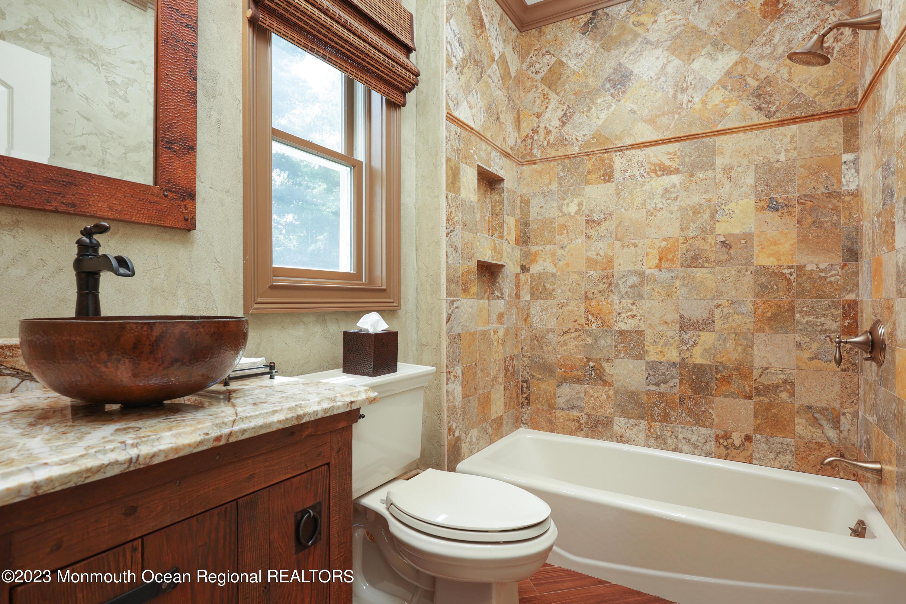 113 Ballantine Road Middletown, NJ 07748 - Photo 9 of 15 a bathroom with a granite countertop sink toilet a mirror and bathtub