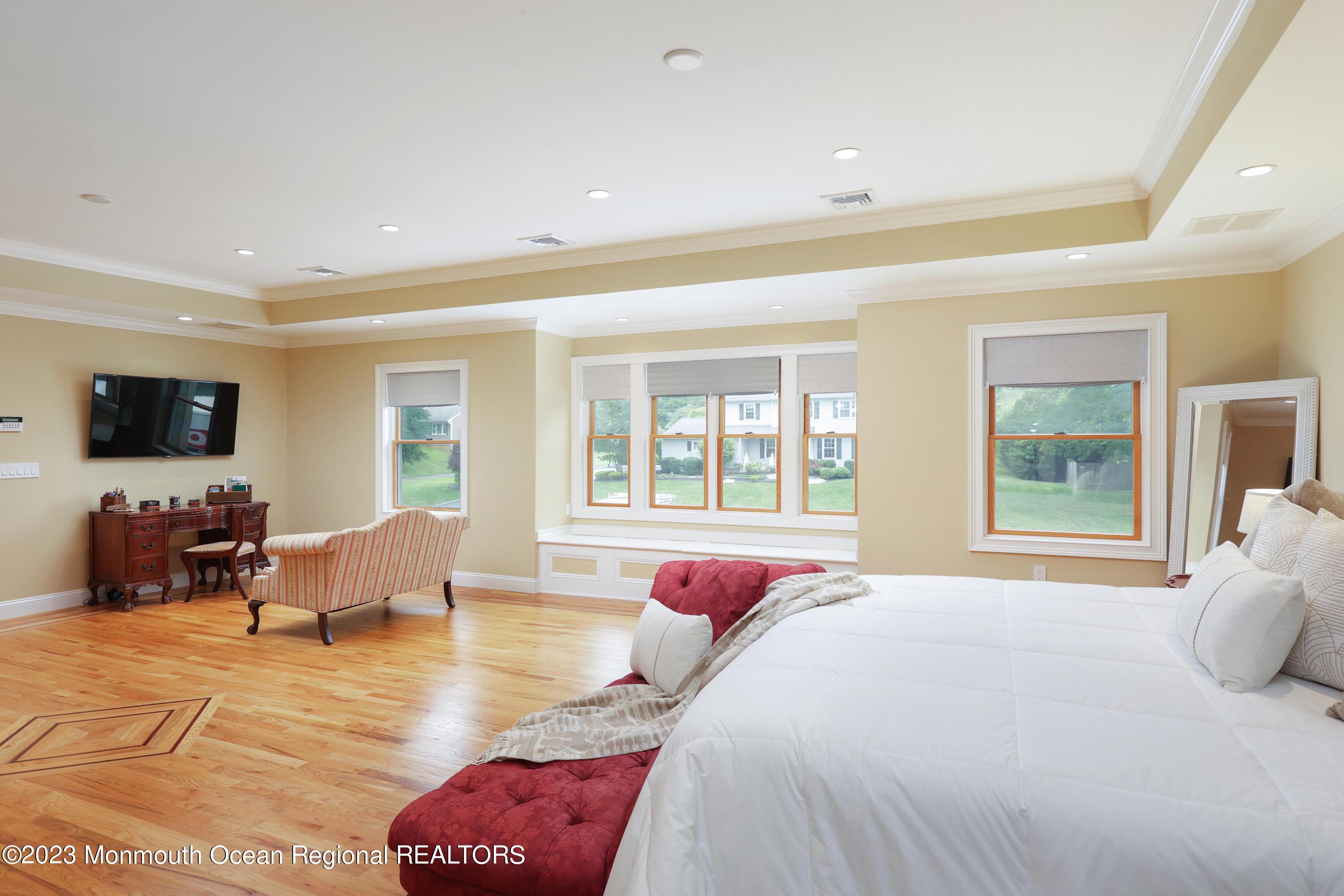 113 Ballantine Road Middletown, NJ 07748 - Photo 10 of 15 a spacious bedroom with a bed and wooden floor