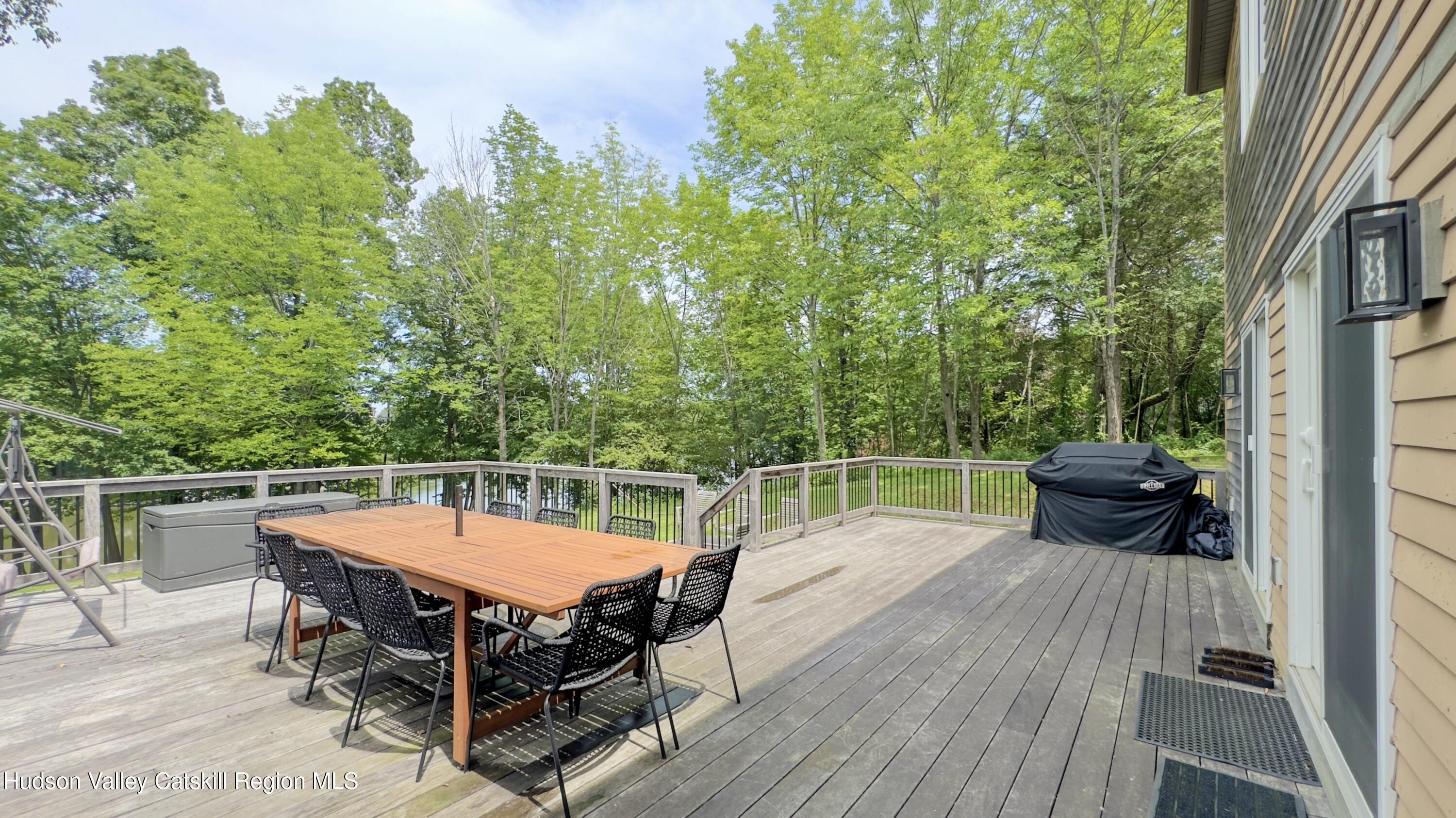 3223 Sleepy Hollow Road Athens, NY 12015 - Photo 38 of 55 a backyard of a house with table and chairs