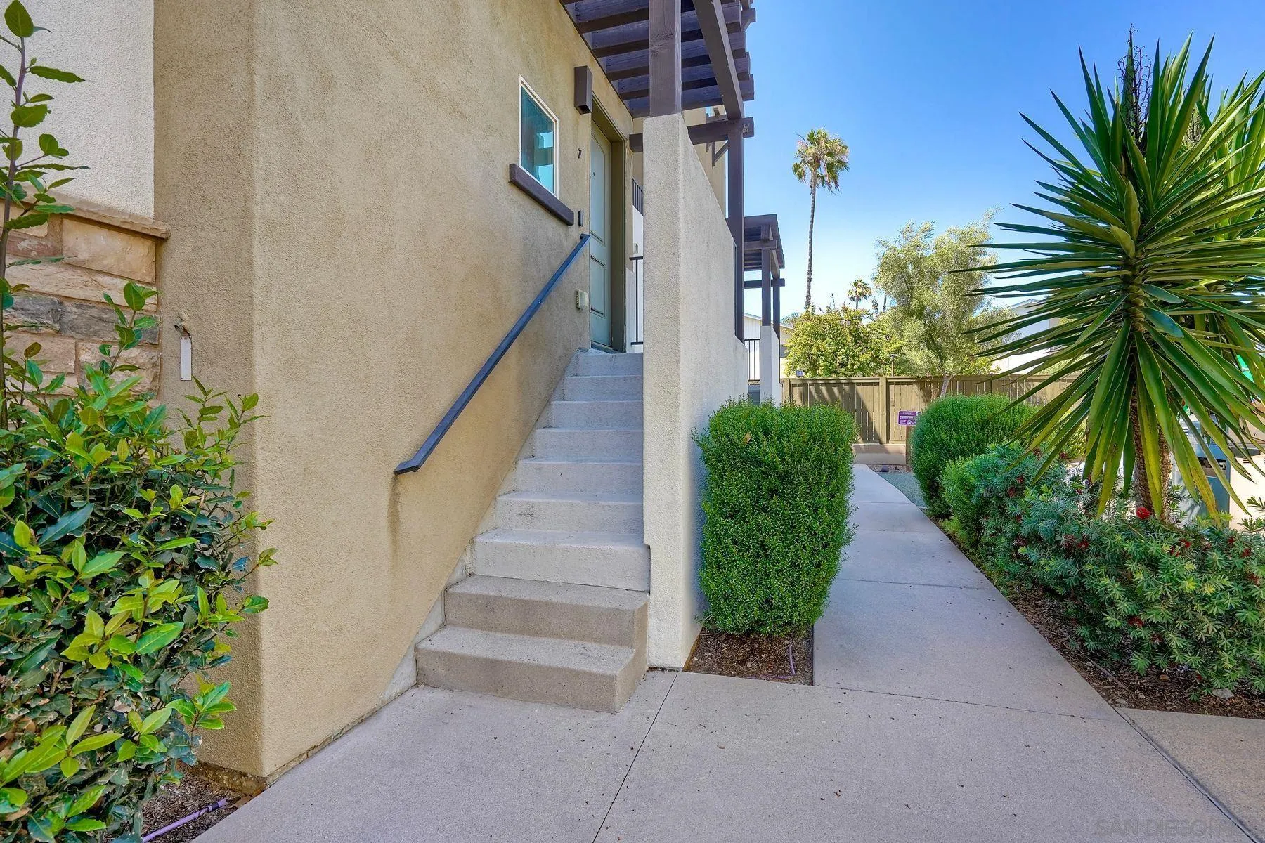 8850 Olive Lane, Unit 7 Santee, CA 92071 - Photo 22 of 27 a view of a pathway of a house with flower garden
