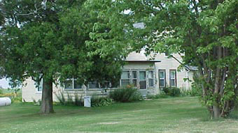 5857 North Cedar Road Mount Morris, IL 61054 - Photo 1 of 6 a front view of a house with a garden and trees