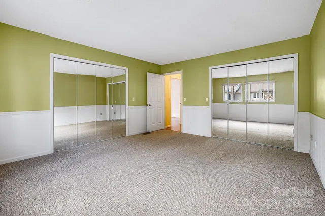 an empty room with windows and entrance