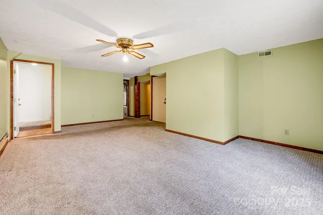 a view of a livingroom with a ceiling fan and window