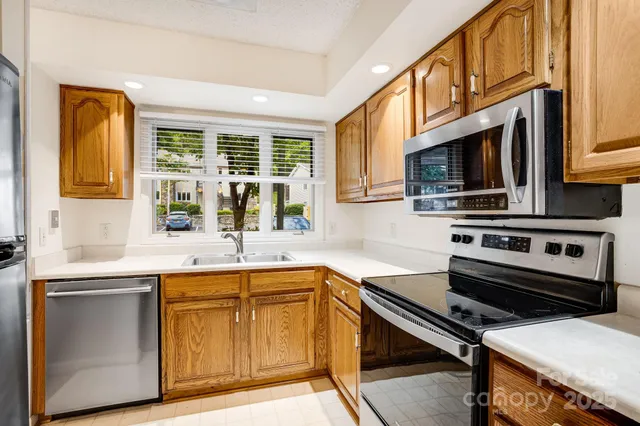 a kitchen with a sink stove top oven and microwave