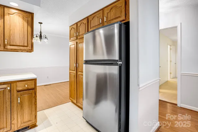 a metallic refrigerator freezer sitting in a kitchen