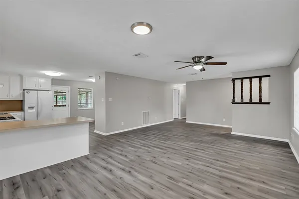 a view of empty room with wooden floor