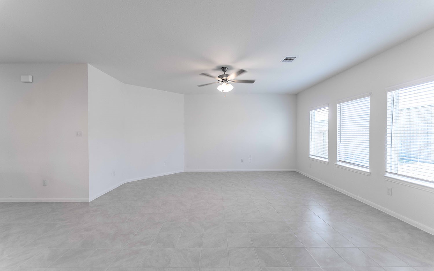 426 Monarch Trail Huntsville, TX 77340 - Photo 11 of 16 an empty room with chandelier fan and windows