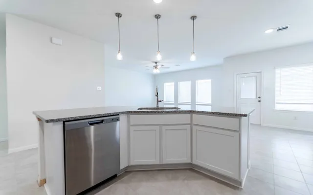 a view of a kitchen with sink and window